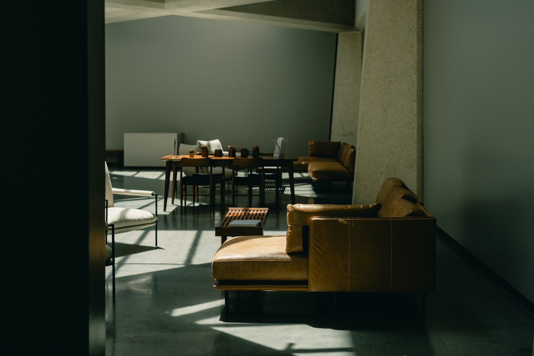 A quiet meeting lounge with leather seating and warm natural light