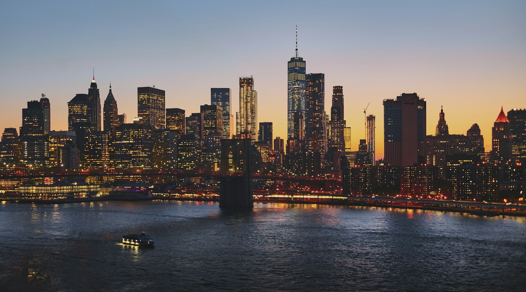 City skyline at dusk seen across the water