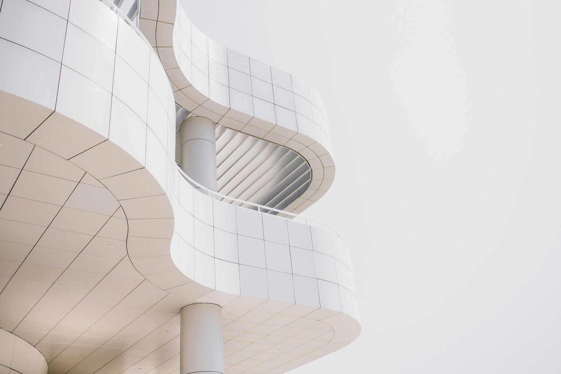 A clean white architectural curve against an open sky