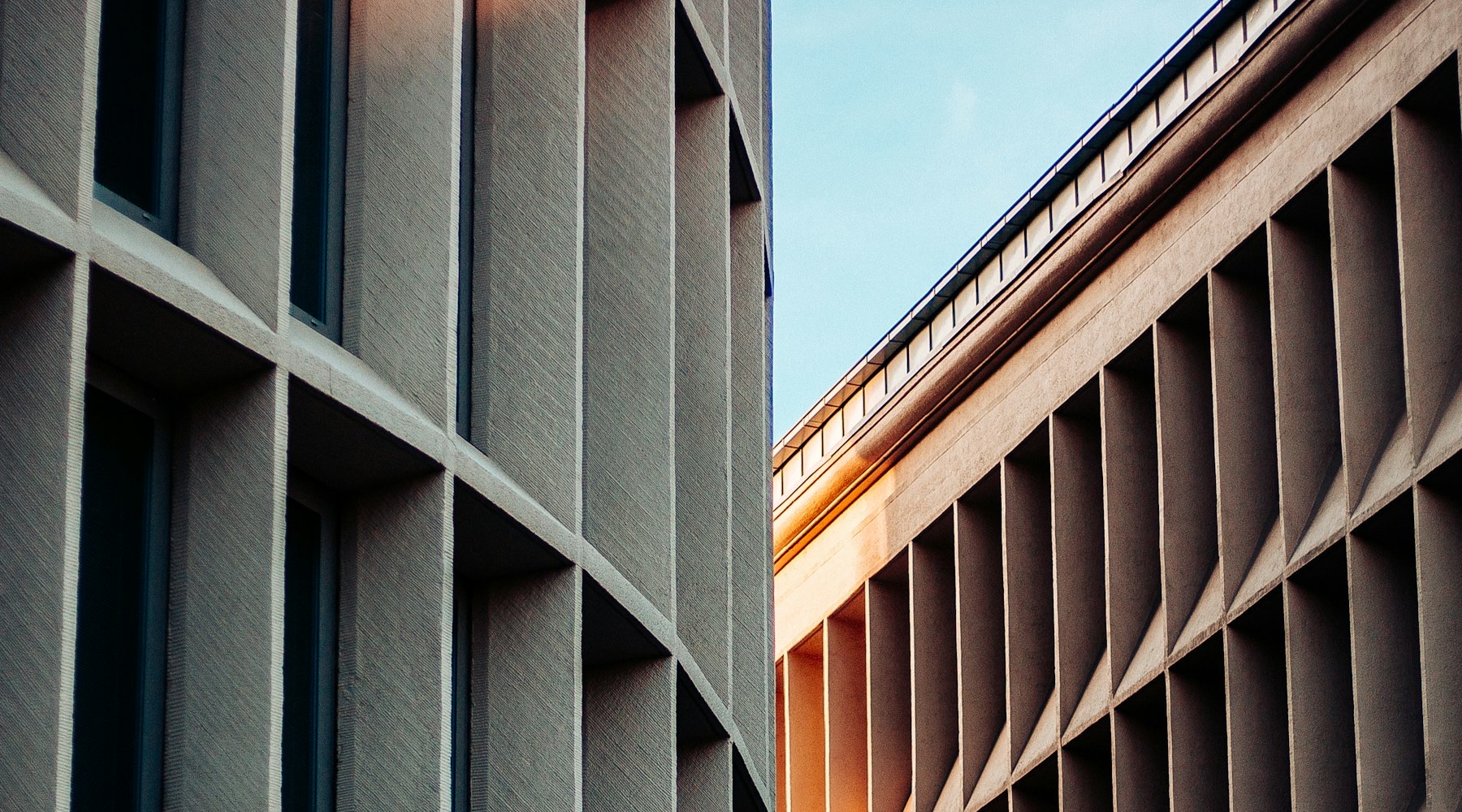 Rhythmic vertical stone fins across a contemporary building facade